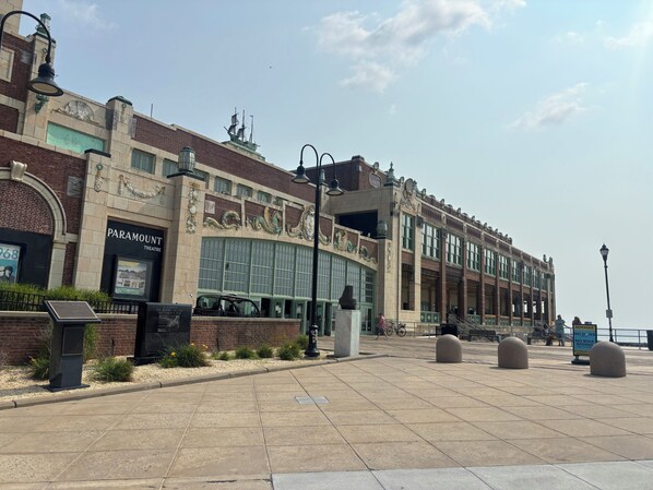 A historic building with a marquee sign, a theater entrance, and a paved walkway.