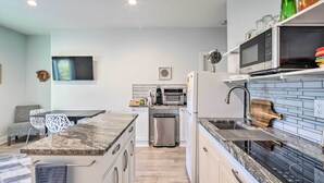 A modern kitchen with granite countertops, a built-in oven, a microwave, and a stainless steel refrigerator. - Mtn-View Retreat in Asheville: Great for Groups! (Asheville)