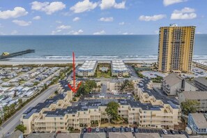 A coastal residential area with a parking lot, a pier, and a tall building. - Wonderful 2-bedroom condo with AC and 2 pools in Myrtle Beach (Myrtle Beach)