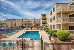 A hotel with a swimming pool, multiple balconies, and a parking area. - Wonderful 2-bedroom condo with AC and 2 pools in Myrtle Beach (Myrtle Beach)