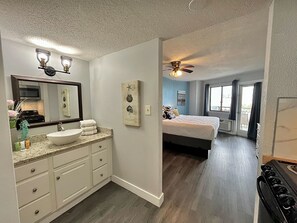A modern bathroom with a vanity, sink, and mirror. - Clean & Cozy 1Br Oceanview Suite @Bluewater! (Myrtle Beach)