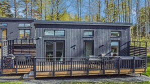 A modern cabin with a deck, large windows, and a staircase. - Villa orion 57 by Interhome (Kemiönsaari)