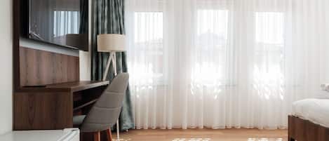 Deluxe Triple Room, City View | Desk, laptop workspace, free WiFi