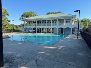 A pool with a white building in the background.