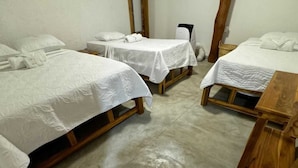 A room with three wooden beds, each with white linens and pillows. - INTERNAL ROOM 103 FIRST FLOOR (IDEAL FOR COUPLES AND FAMILIES) (Bolívar)
