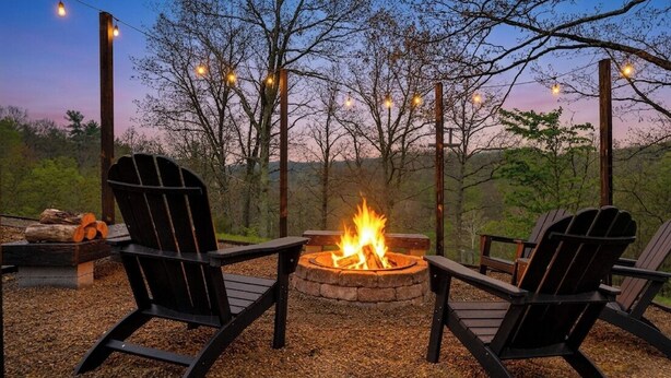 A fire pit with chairs around it, string lights, and trees in the background. - Hickory Ridge Homestead | Free Farm Tours + Firepit (Augusta)