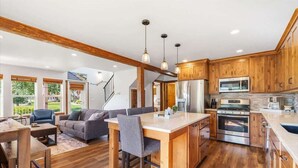 A spacious kitchen with wooden cabinets, a central island, and stainless steel appliances. - Waterfront Dover Bay House: Walk to Marina & (Dover)