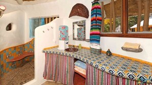 A bathroom with a curved sink, a mirror, a towel rack, and a window with a view of trees. - Private Sayulita Estate 3 Villas, 3 Pools, Ocean Views, Walk to Beach, Sleeps 20 (Sayulita)