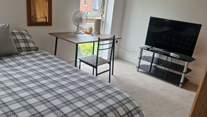 A bedroom with a bed, a desk, a chair, a television, and a window. - Two rooms in a very quiet and clean environment. Central to getting services (Southampton)