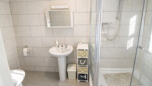 Un bany amb vàter, rentapel i dutxa.