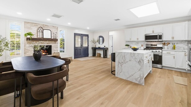 A modern kitchen with white cabinets, a marble island, and a built-in microwave. - San Diego Family Getaway, 4BR Home Near Beaches & Balboa (Spring Valley)