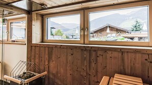 A wooden interior with a window view of a mountain landscape, a drying rack, and a wooden bench. - 2A Morgensonne/mit Weitblick by Interhome (Bad Hofgastein)