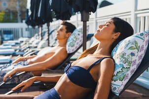 Seasonal outdoor pool, open 9:00 AM to 9:00 PM, pool umbrellas