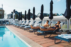 Seasonal outdoor pool, open 9:00 AM to 9:00 PM, pool umbrellas