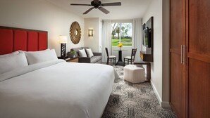 A hotel room with a large bed, a desk with a chair, a television, and a view of the outdoors. - Marriott Shadow Ridge Palm Desert 2-bedroom (Palm Desert)