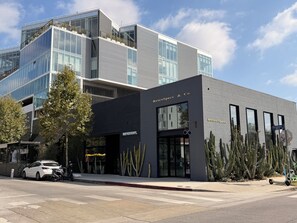 A modern building with a storefront named 'RetroSpecs & Co.' - Adorable 1-bedroom bungalow with AC in lively Los Angeles (Los Angeles)