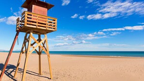 A wooden lifeguard tower on a sandy beach with a clear blue sky. - Le Beaupré by Interhome (Canet-Plage)