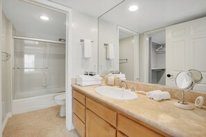 A modern bathroom with a glass-enclosed shower, a sink with a vanity, and a large mirror. - Toluca Lake Townhome, Central to Hollywood attractions (Los Angeles)