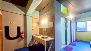 A hallway with a U-shaped mirror, a sink, and a fire extinguisher. - New Me U Hostel (Chiang Mai)