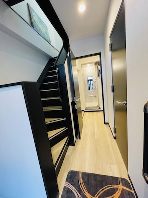 A staircase with a black railing and a patterned rug at the bottom. - 2minN.Ikebukuro,5minIkebukuro,15minShinjuku.3FL3RMhouse,WiFi,smartcheck-in.Max10 (toshimakuhoncho)