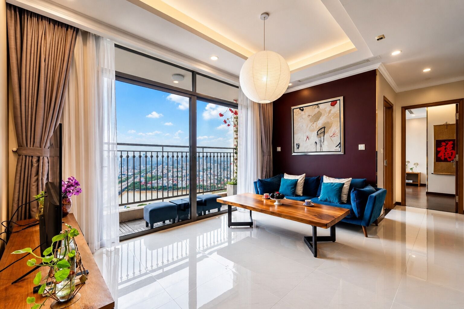 A modern living room with a sofa, coffee table, and a view of a cityscape through large windows.