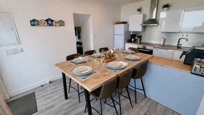 A modern kitchen with a dining area set for six.