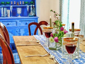 A dining table set with glasses, cutlery, and a candle. - 4 bedroom accommodation in Bovey Tracey (Bovey Tracey)