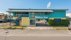 A motel with a blue and yellow exterior, a sign reading 'Pacific Motor Inn,' and a visible staircase leading to the entrance. - Pacific Motel Evans Head (Evans Head)