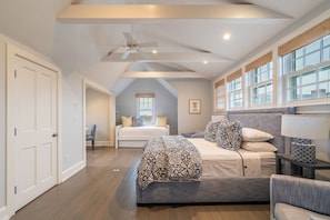 A bedroom with a large bed, a ceiling fan, and a view of the outside through a window. - 8BR Pondfront Estate with Ocean Views, Pool, Spa, Tennis and Golf Club Access (Nantucket)