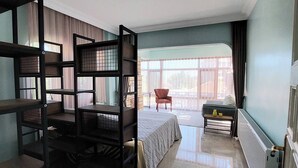A room with a bunk bed, a desk, a chair, and a large window. - Tranquil 3-bedroom House in Eğirdir With Stunning Views (Egirdir)