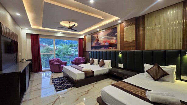 A modern hotel room with a bed, seating area, and a balcony with a view. - Hotel Summer Nest - Bhagsu Waterfall  (Dharamshala)