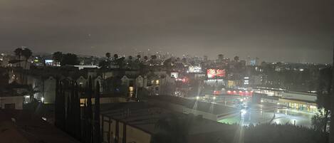 A nighttime cityscape with a prominent hotel sign.