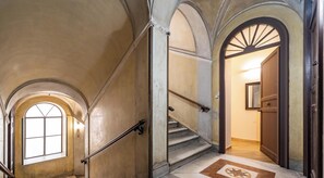 A staircase with a handrail, a door with a mirror, and a window with a view. - Relaxation and comfort within walking distance of everything, ideal for families, couples and small groups (Palermo)