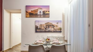 A dining area with a glass table, chairs, and a bowl of fruit. - Relaxation and comfort within walking distance of everything, ideal for families, couples and small groups (Palermo)