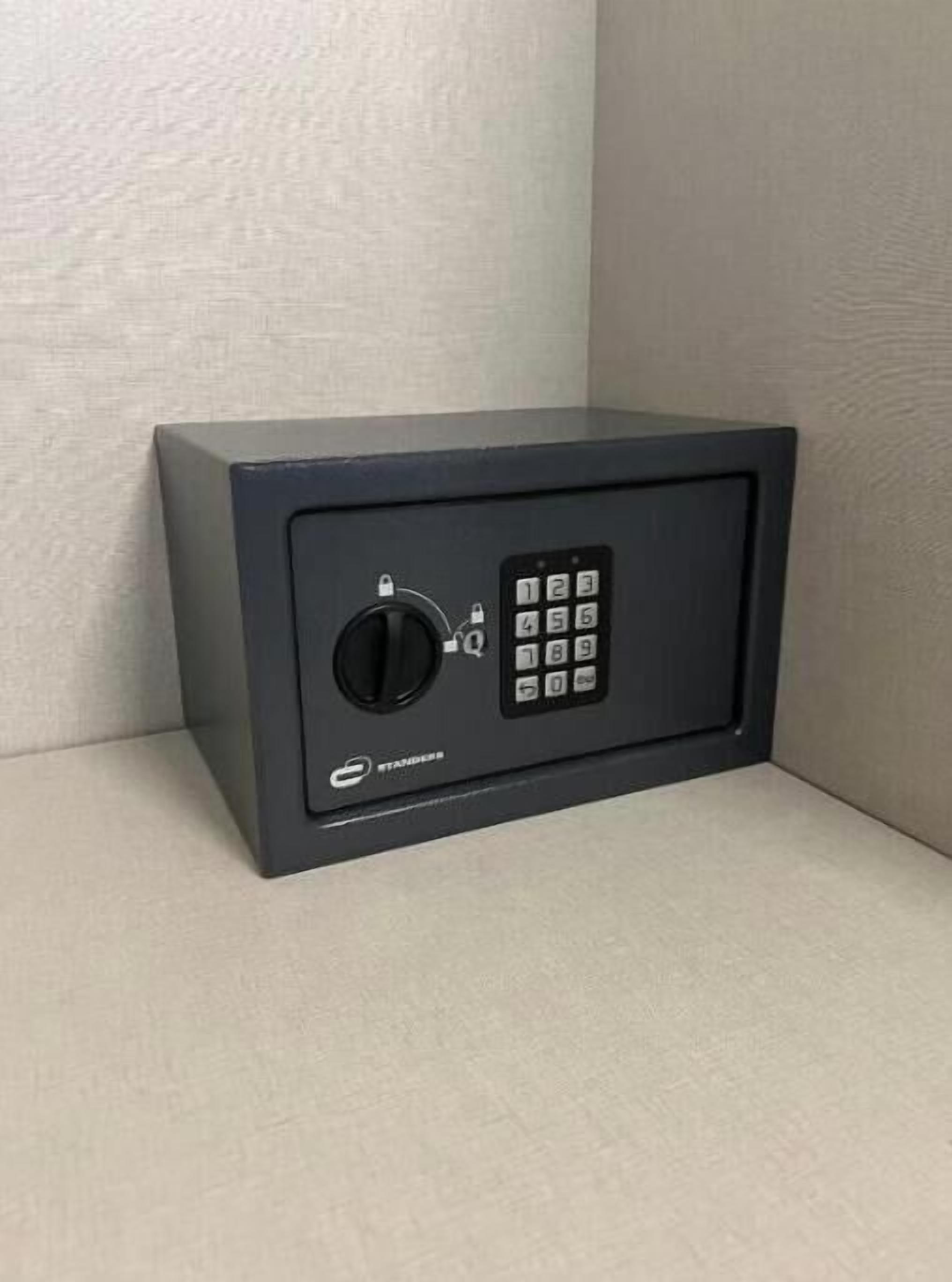 A black safe with a numeric keypad and a combination lock.