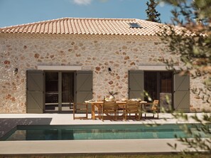 A stone building with a tiled roof, a pool, and outdoor furniture. - Conte Maris IV - The True Mediterranean Escape! (Zakynthos)