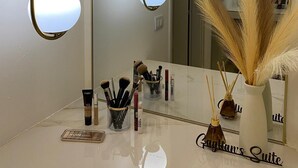 A bathroom with a vanity, a mirror, and two pendant lights. - Suites within walking distance of Lake Como (Como)