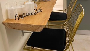 A modern kitchen with a wooden countertop, a built-in refrigerator, and a gold chair with a black cushion. - Suites within walking distance of Lake Como (Como)
