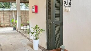 A corridor with a bench, a door labeled 'THINKING ROOM,' and a potted plant. - Ena Boutique Hotel & Cafe (Chiang Mai)