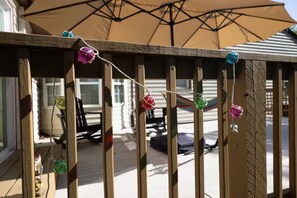 A wooden deck with a string of colorful ornaments. - KC World Cup-Game Day Stay-1 min to Arrowhead (Kansas City)