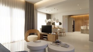 Ein modernes Wohnzimmer mit Flachbildfernseher, einem Essbereich und einer Küche.