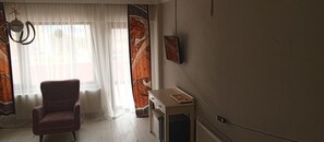 Habitació quàdruple familiar | Sala d'estar | Televisor 