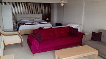 Family Quadruple Room | Living area | TV