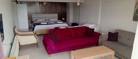Family Quadruple Room | Living area | TV