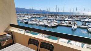 En balkon med udsigt over en havn fyldt med både.