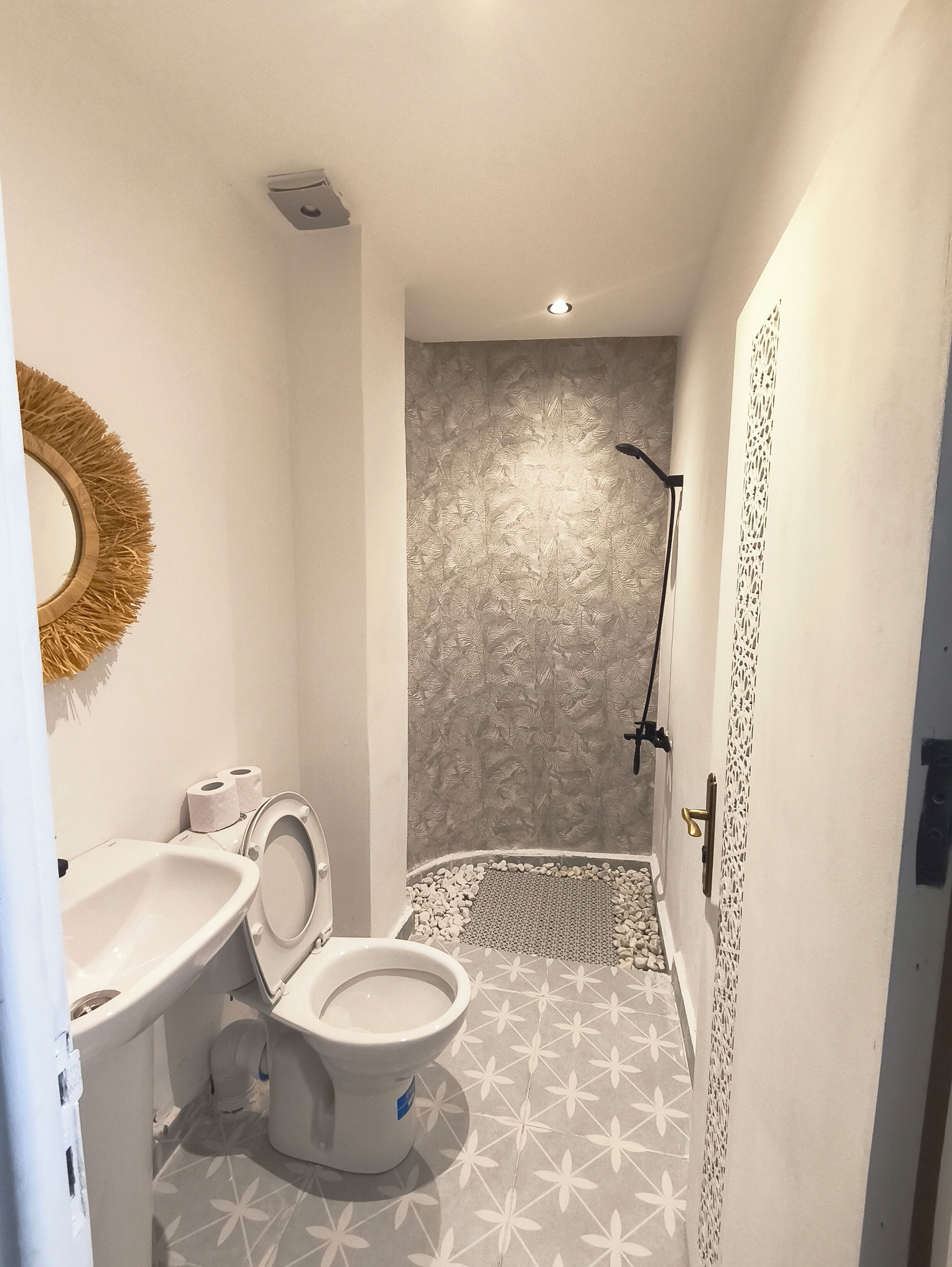 Un baño con inodoro, lavabo y ducha.