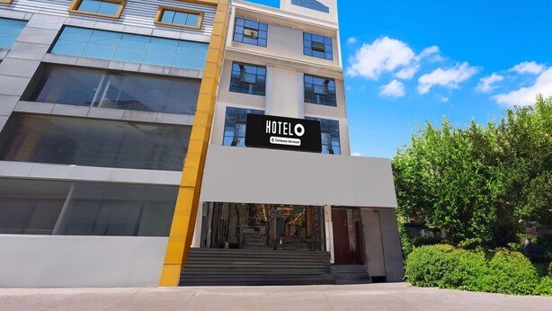 A modern hotel building with a prominent sign reading 'HOTELO'.