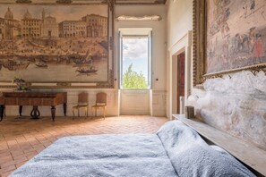 A room with a bed, a desk, a chair, and a large window. - Spectacular 18th-century Mansion with pool (Terni)