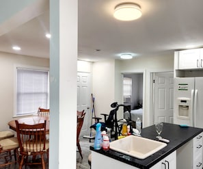 A compact kitchen with a sink, countertop, and a refrigerator.