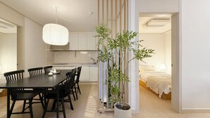 A modern interior with a dining area, kitchen, and a bedroom. - Family-sized | Premium Stay | Near Incheon Airport | 5 minutes to Unseo Station (Incheon)